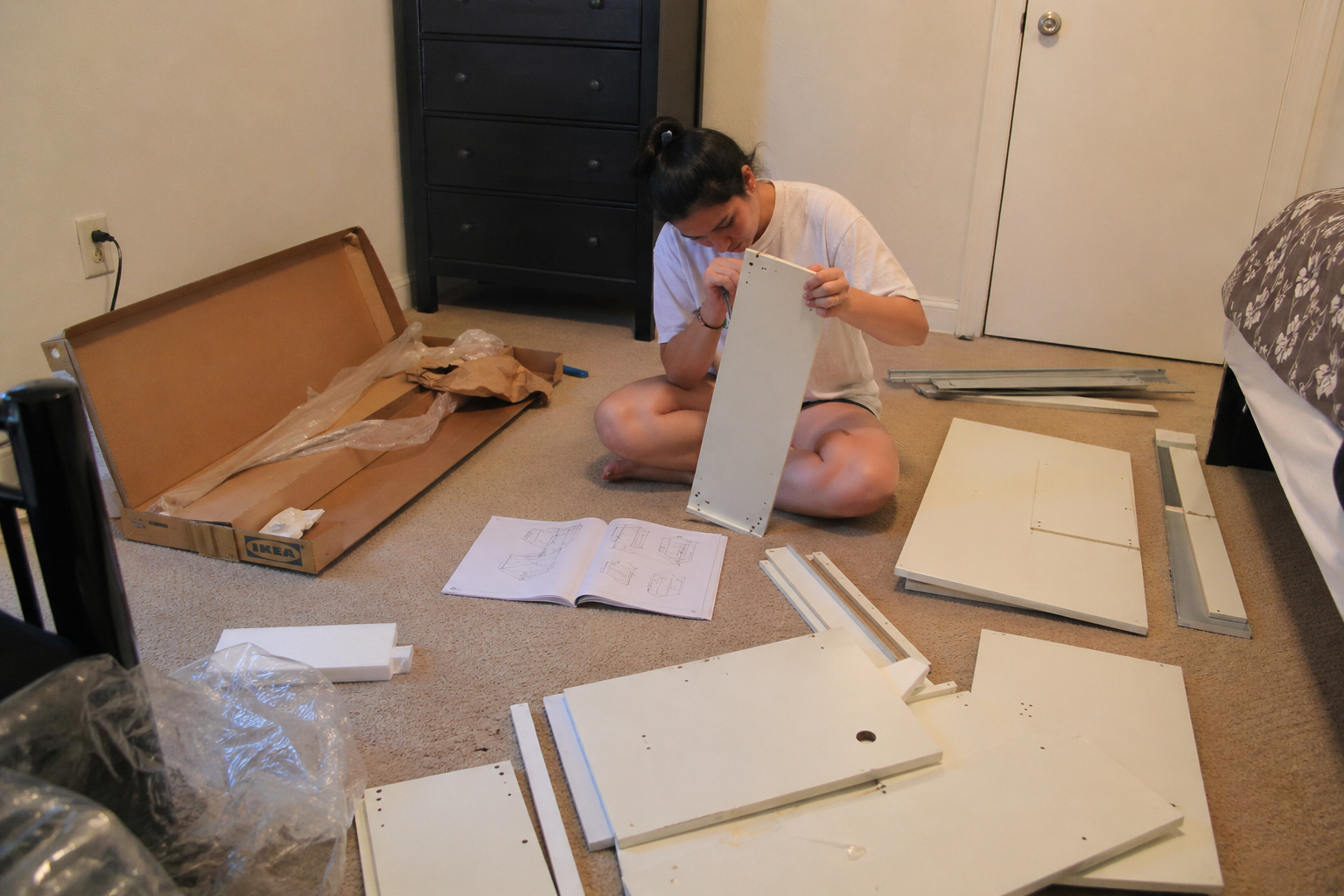 IKEA furniture parts laid out on the floor ready to assemble